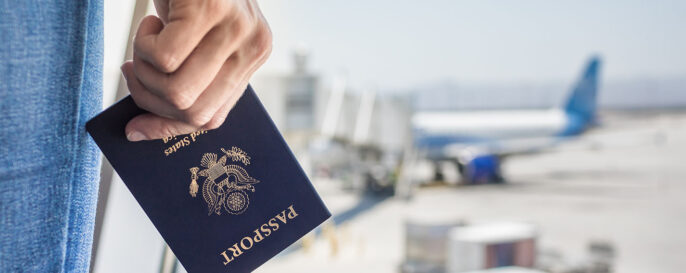 Hand holding passport at airport