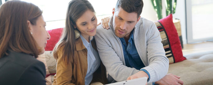 Couple reviewing paperwork with realtor