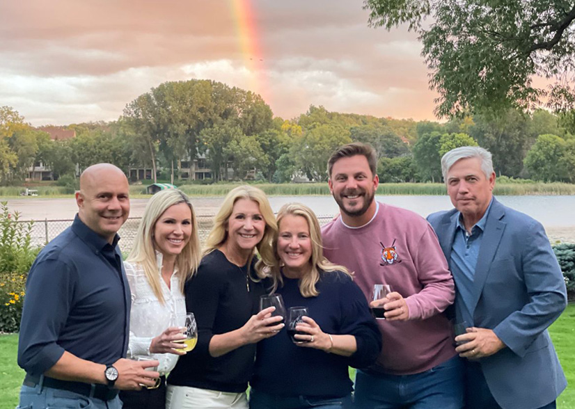 Plus Relocation team of six with rainbow in background