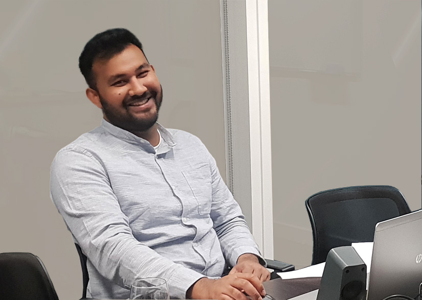 Plus Relocation employee smiling while working