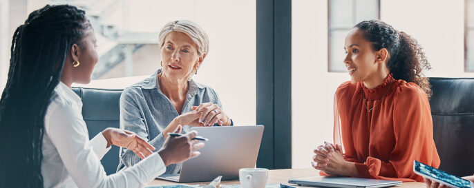 business metting with three women engaged in conversation