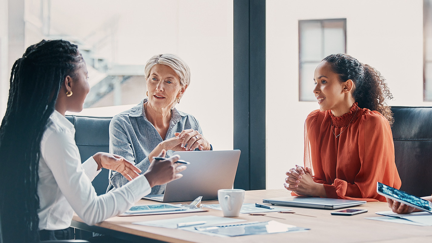 business metting with three women engaged in conversation