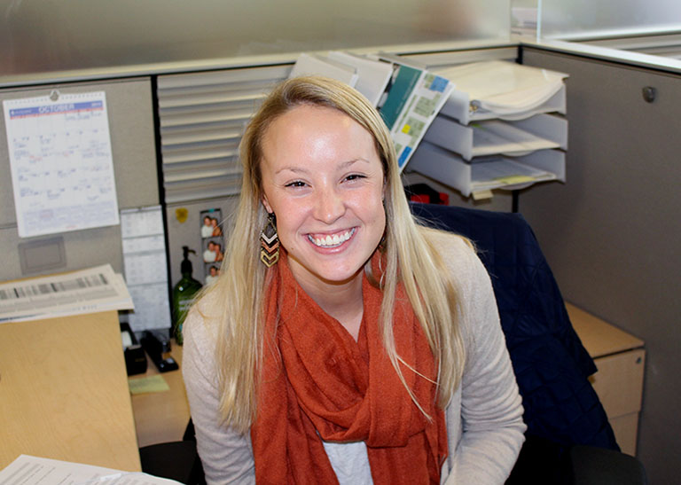 Plus Relocation employee smiling while working