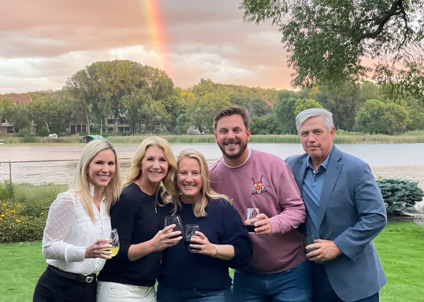 Plus Relocation team of five with rainbow in background