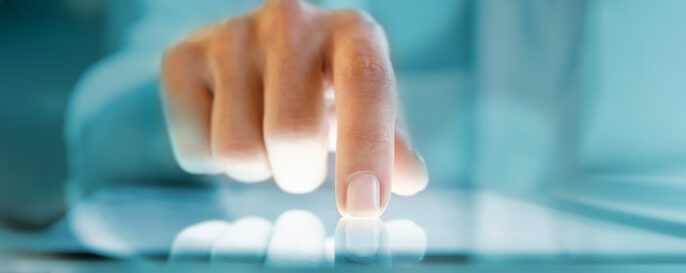 Closeup photo of a hand touching a digital screen